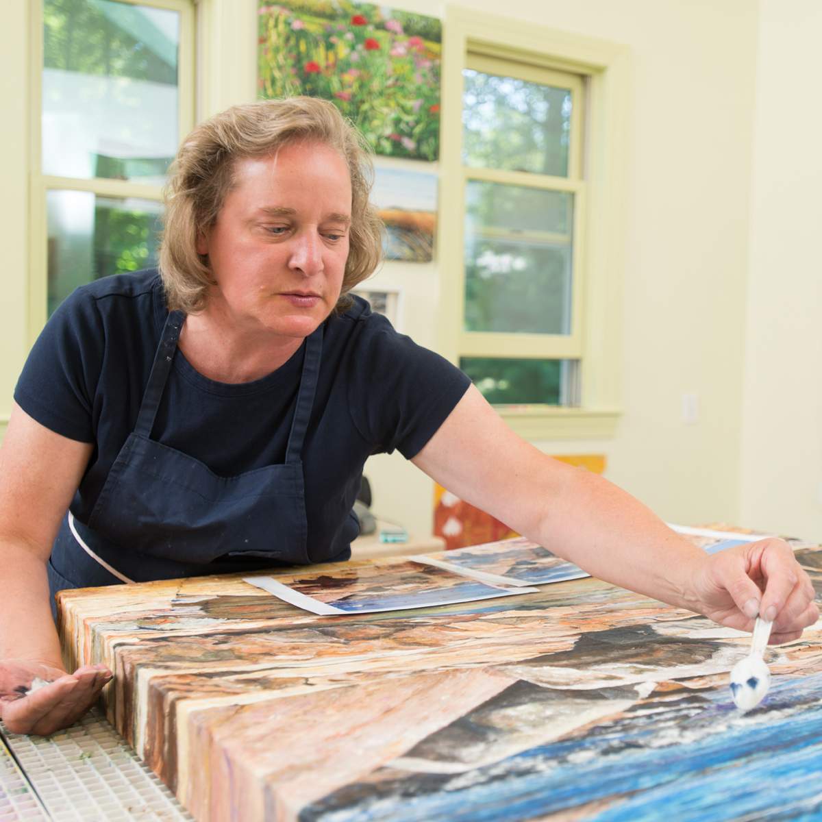 A woman working on a painting.