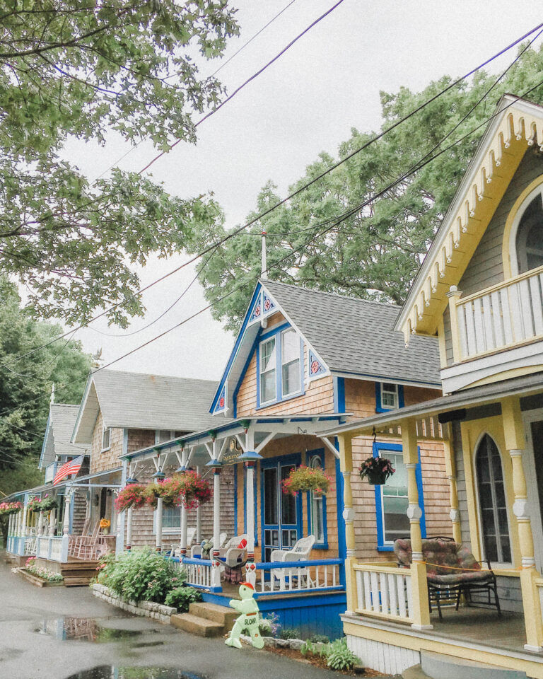 This is one of the narrow roads that goes through the neighborhood of Gingerbread Houses. The architectural style is known as Carpenter Gothic, common in North America in the late nineteenth century. All the cottages are painted in different bright colors, and most will be painted with at least a few different colors. They are also embellished with unique jigsaw decorations of almost endless variety usually around the trimming of the porches, or window frames. They all usually have a covered front porch, and intricate carvings around the bannisters as well. Many also have beautiful hydrangeas or other flowers growing in their very small front and side yards.