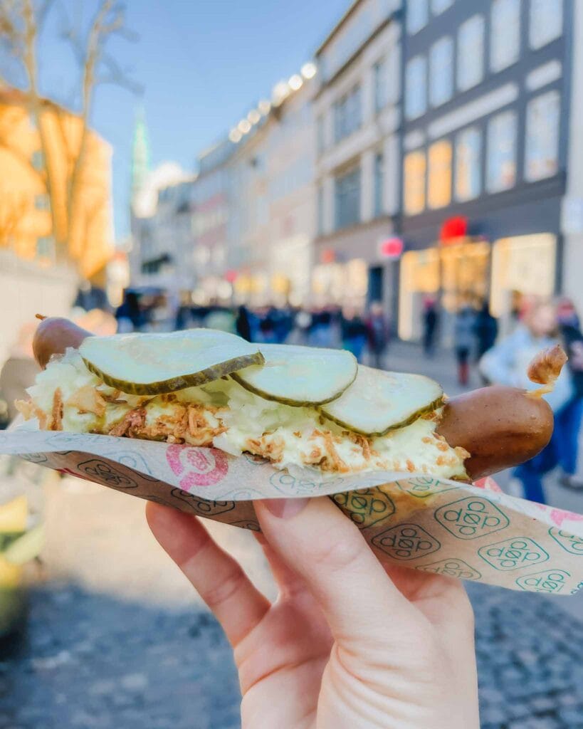 This photo of a hotdog is one of the most popular in Copenhagen. If you're looking where to stay in Copenhagen your first time you can find a few different locations of this chain. This hotdog that I chose with mayonnaise, fried onions, and pickles. It was delicious!
