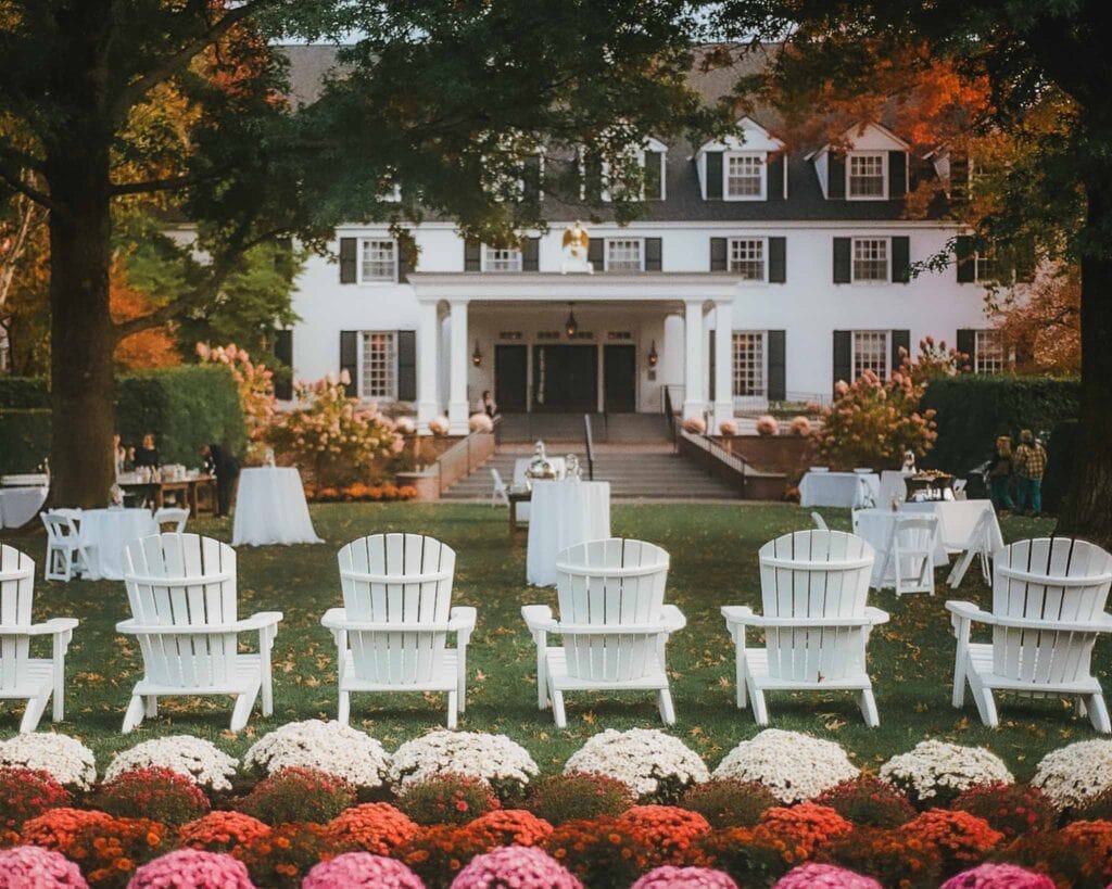 One of the best places to visit on a New England road trip is Woodstock, Vermont. Make sure to visit the Woodstock Inn and Spa which appears like a large, white mansion with a large porch with pumpkins, mums, and fall foliage adorning the large front lawn.