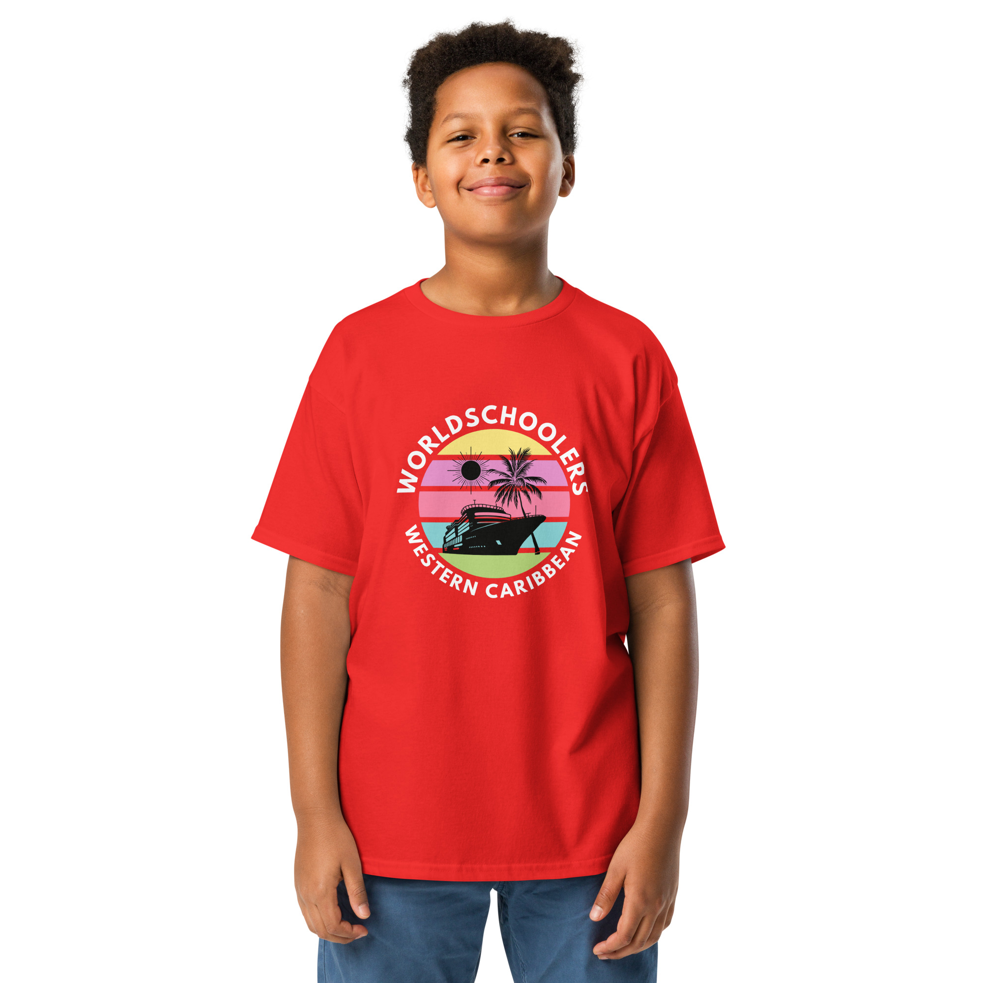 Sunny boy wearing a vibrant red graphic tee featuring a tropical boat design with the text “Worldschoolers Western Caribbean” for kids' travel themed fashion.
