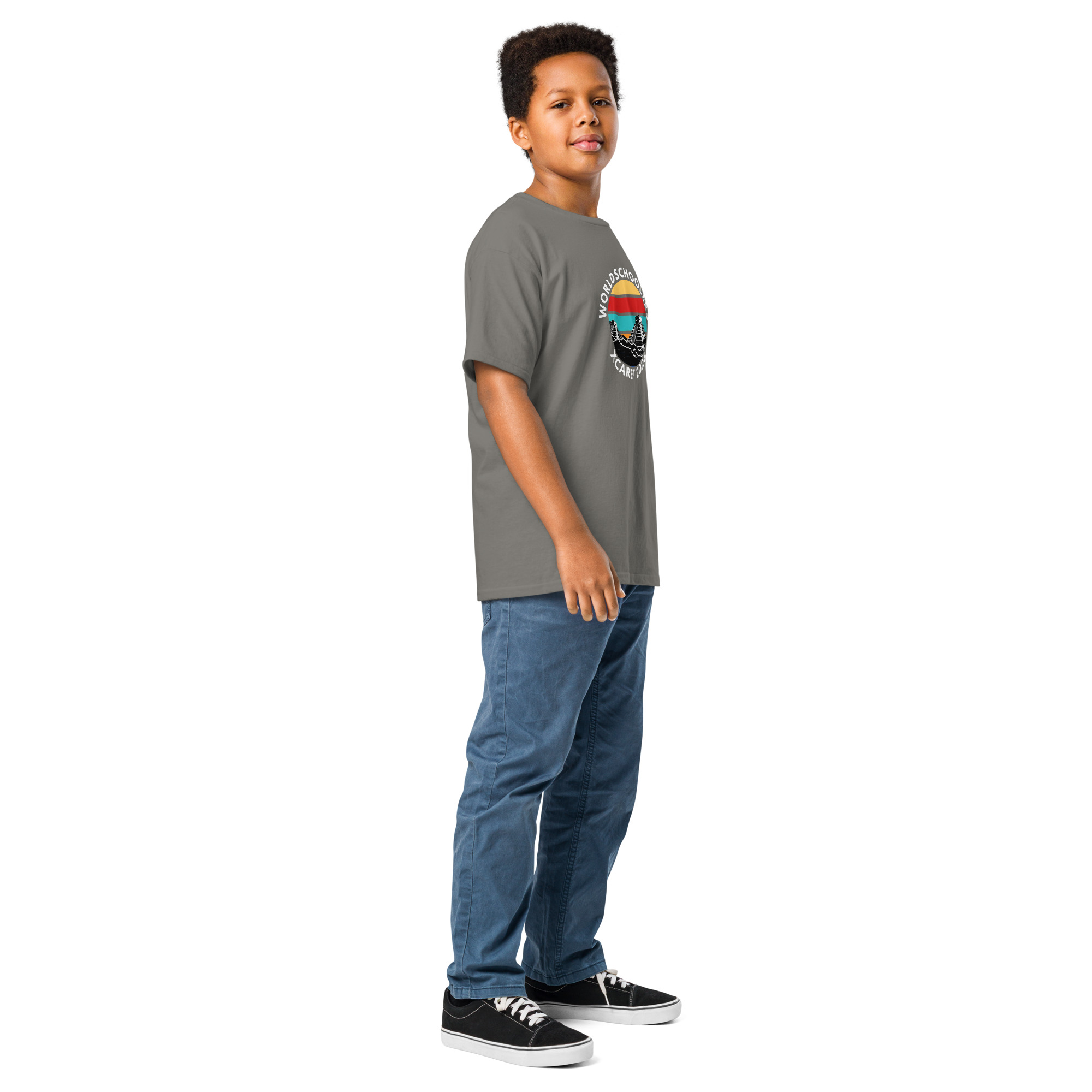 Young boy wearing a Xcaret 2026 Youth Classic T-shirt, standing confidently.