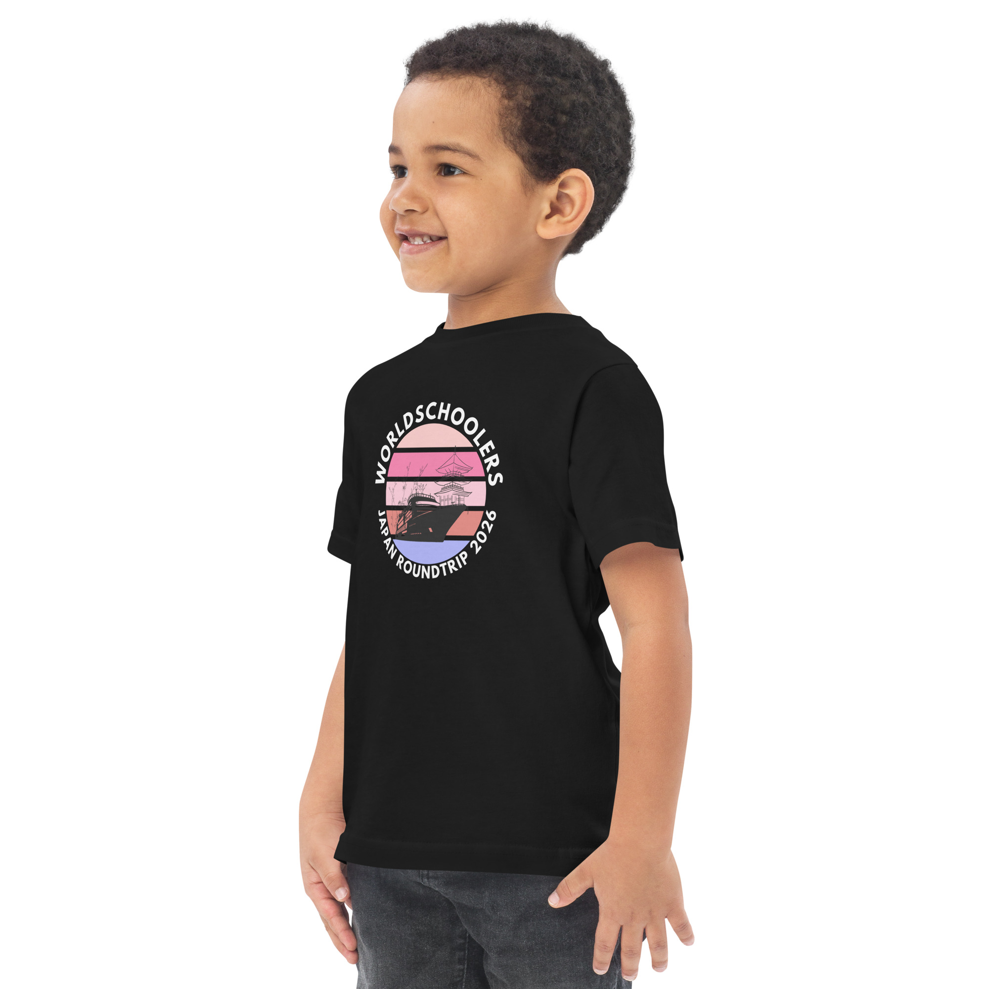Toddler boy wearing a black jersey T-shirt with a Japan roundtrip graphic design, perfect for travel-themed kids' fashion.