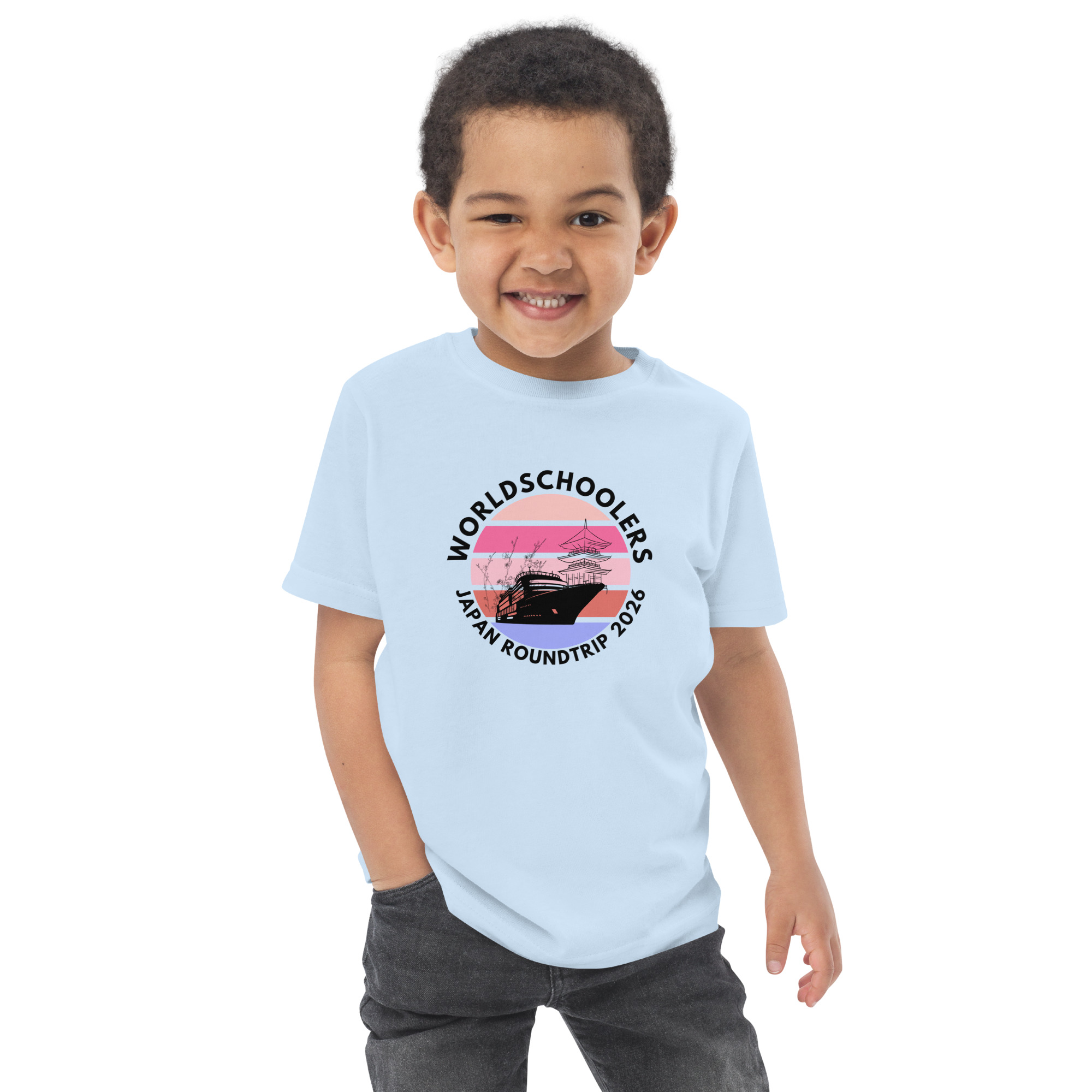 Adorable toddler wearing a light blue jersey T-shirt with a Japan roundtrip 2026 graphic, perfect for travel-themed kids' apparel.