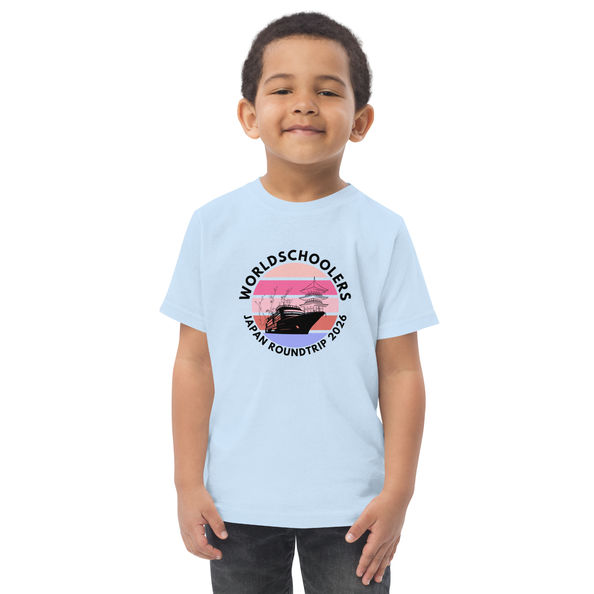 Adorable toddler wearing a light blue jersey T-shirt with a Japan roundtrip graphic design, perfect for travel-themed kids' apparel.