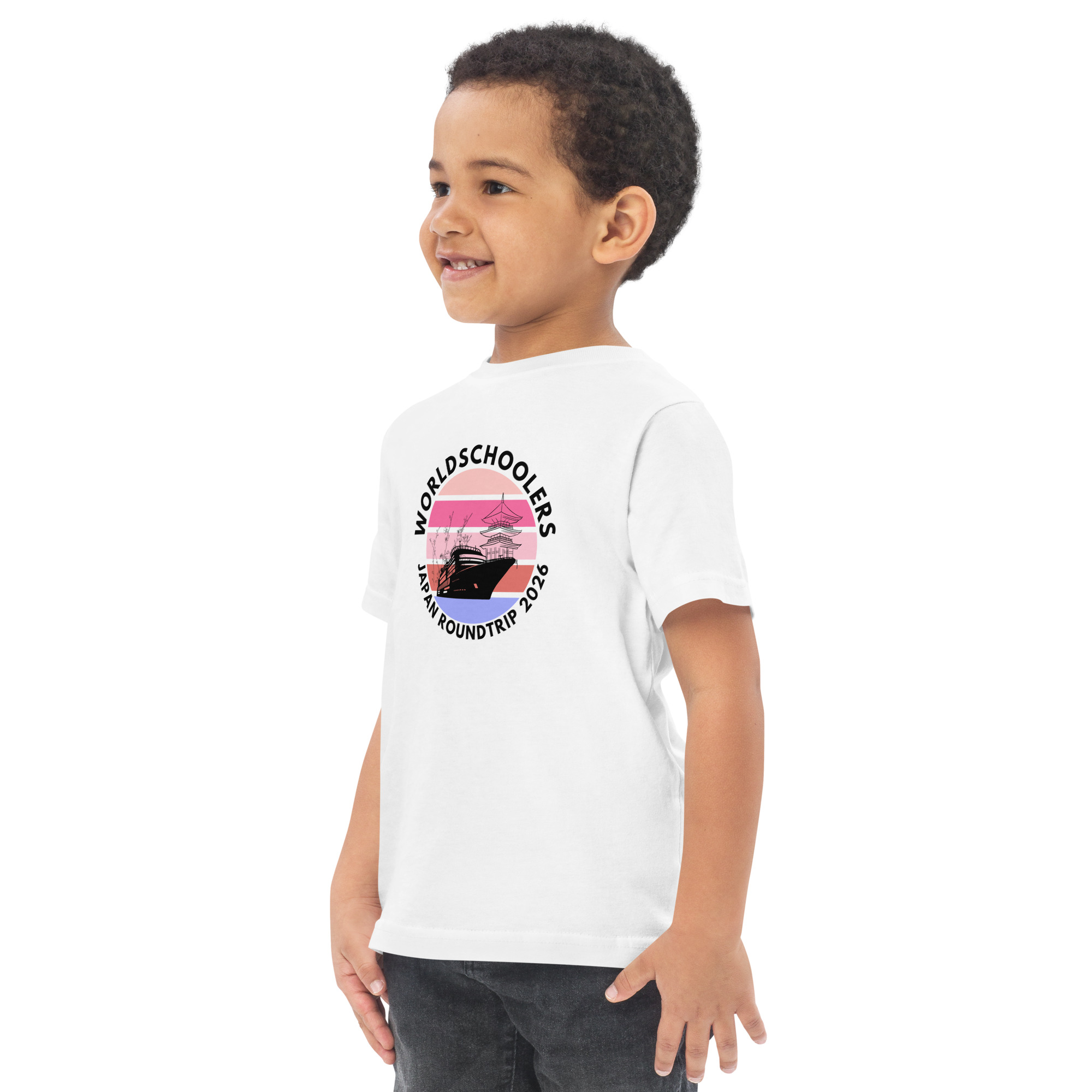 Adorable toddler wearing a white jersey T-shirt with a Japan roundtrip graphic design, perfect for travel-themed kids' fashion.