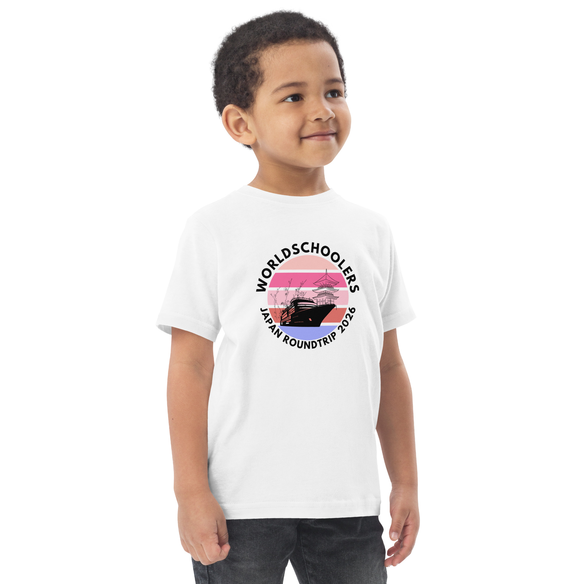 Adorable toddler wearing a Japan Roundtrip 2026 graphic tee featuring a ship and sunset design, perfect for travel-themed kids' apparel.