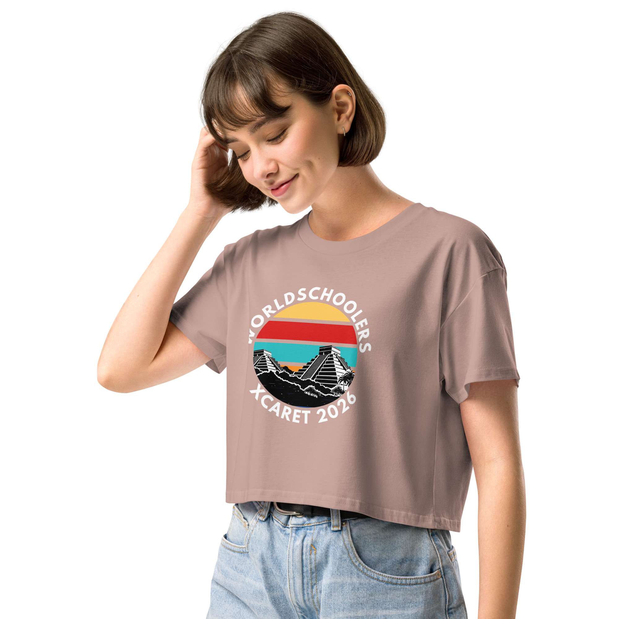 Women's crop top featuring a colorful Xcaret 2026 design with retro sunset, pyramid, and ocean waves, perfect for travel and vacation enthusiasts.