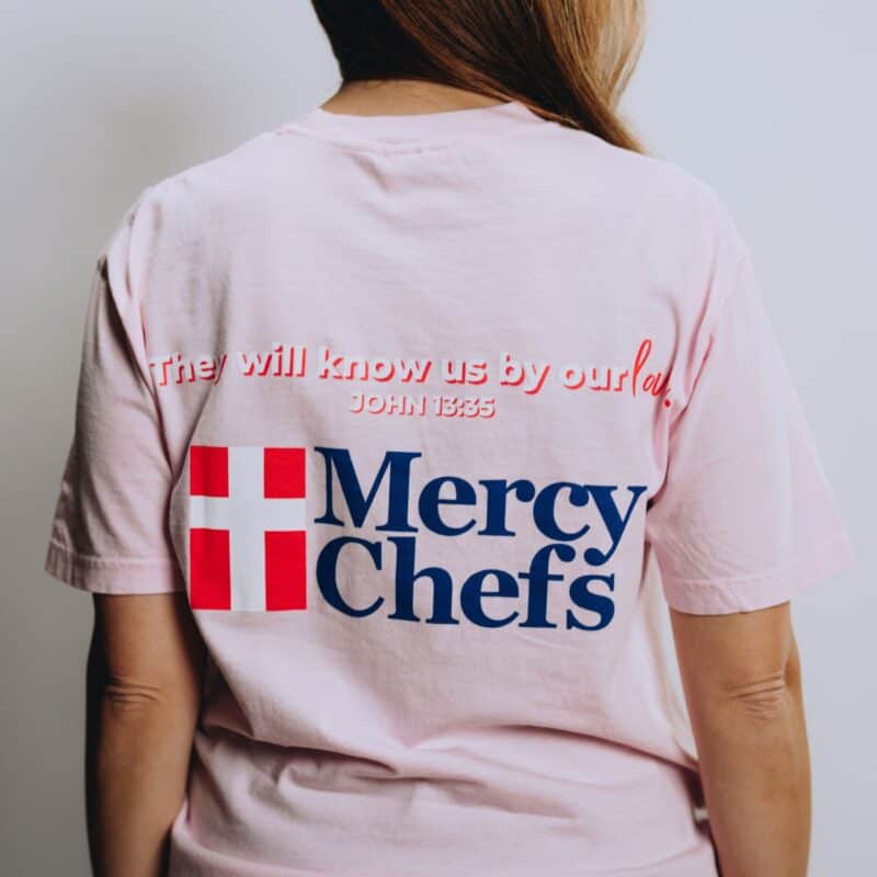 A back view of Mercy Chefs' "Love the One" t-shirt