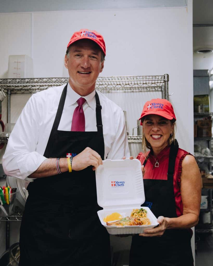 overnor Glenn Youngkin and First Lady Suzanne Youngkin preparing a hot meal at Mercy Chefs.