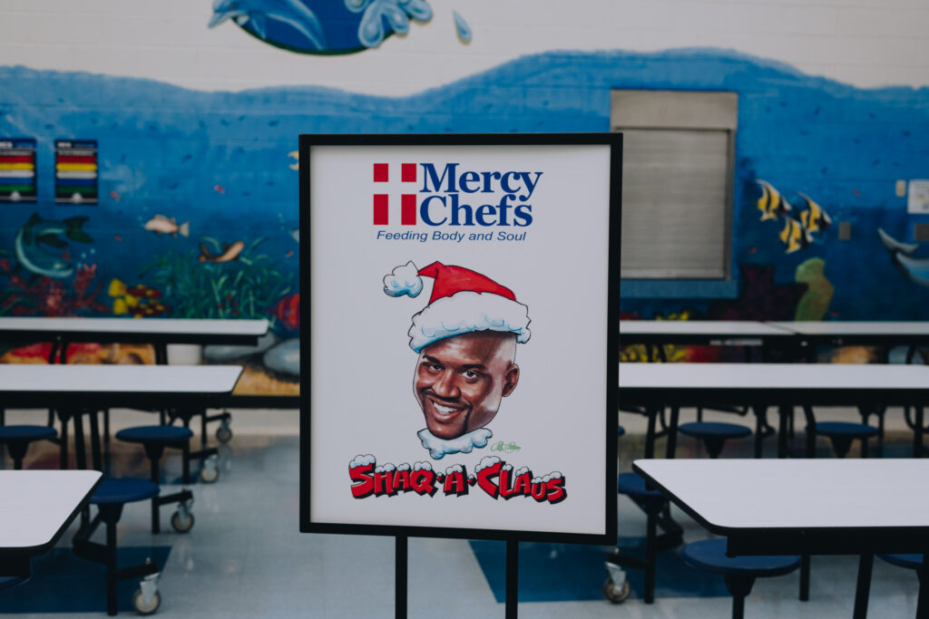 A Mercy Chefs and Shaq-a-Claus sign.
