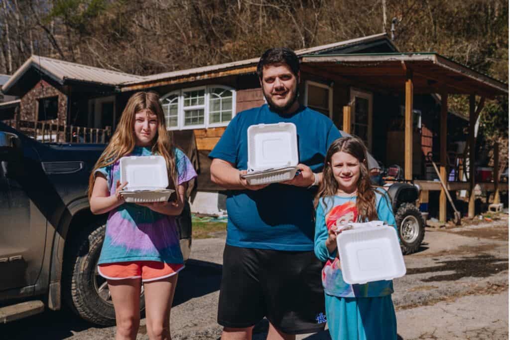 A family receiving Mercy Chefs meals in the aftermath of the floods in Kentucky.