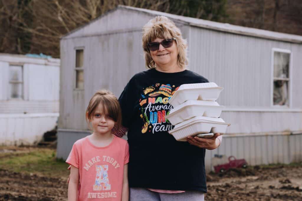 A mother and her daughter receiving Mercy Chefs meals in the aftermath of the Kentucky flooding.