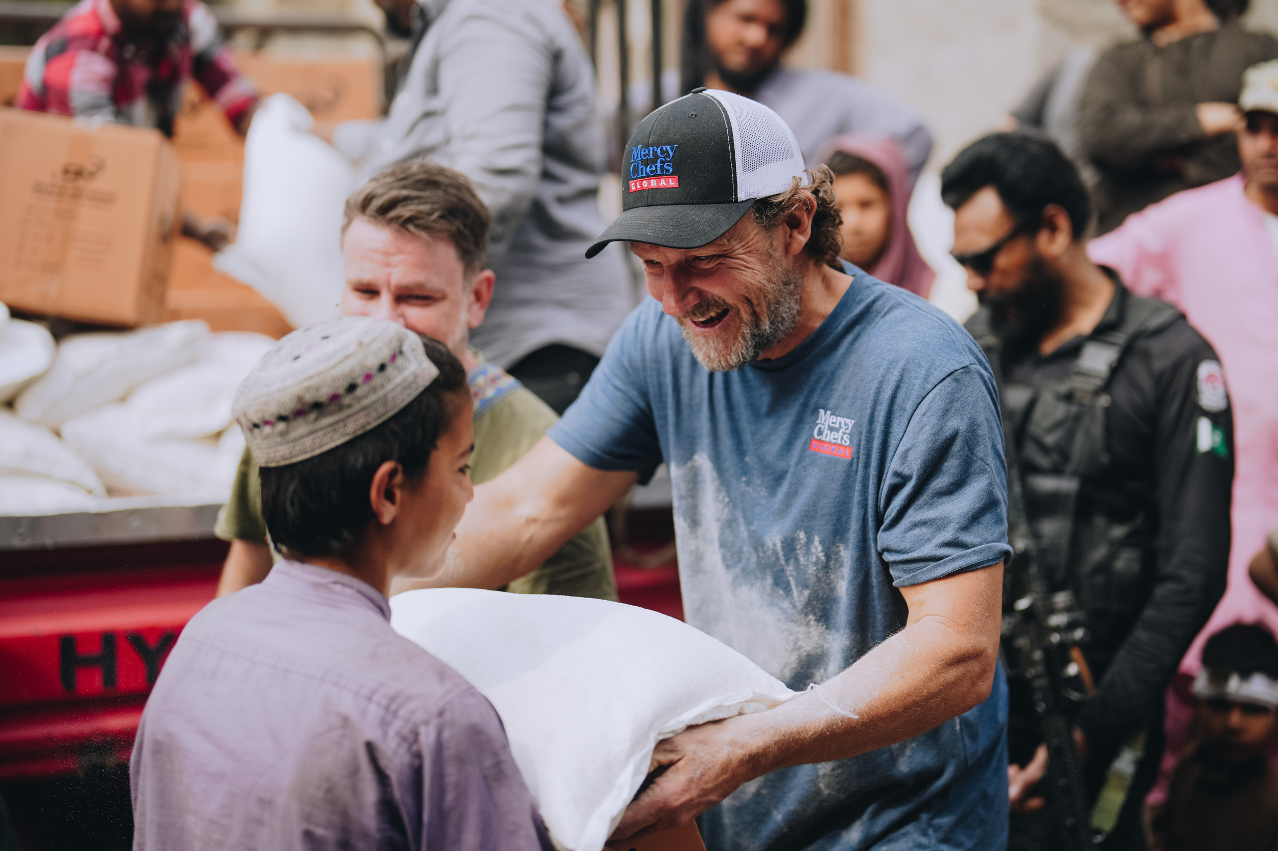 A Global team member distributes groceries in Pakistan