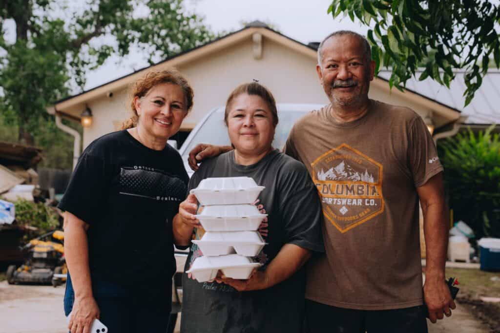 A family affected by the floods in Kerr County, TX, receiving Mercy Chefs meals