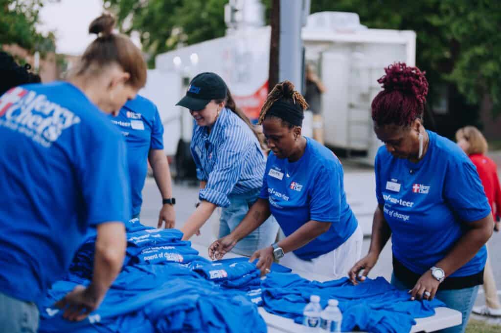 Volunteers organize shirts at Mercy Chefs' HQ