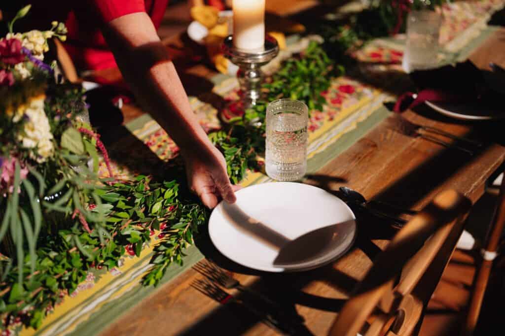 A hand setting the table