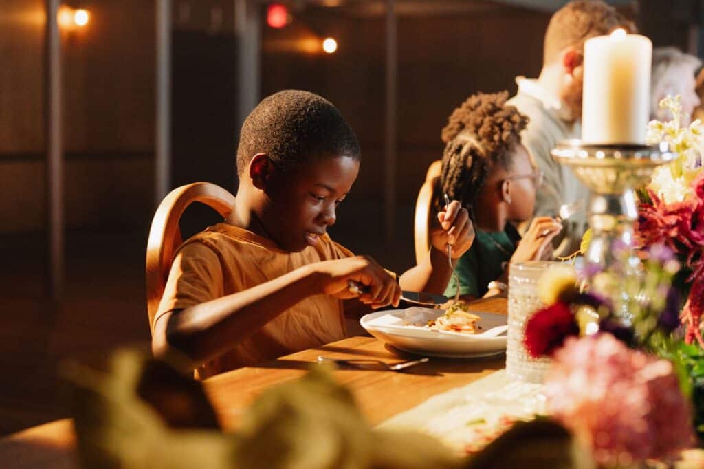 A child enjoys a hot meal at Mercy Chefs' table