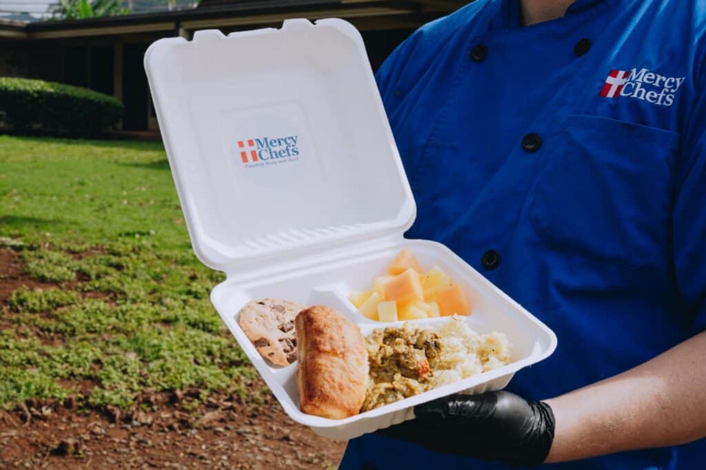A hot plate of chicken curry with fire-roasted vegetables, citrus-herb jasmine rice, fresh fruit, brioche toast, and a cookie