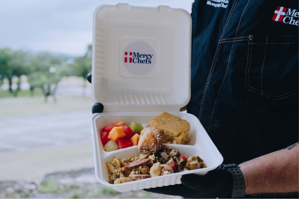 A warm plate of Jambalaya-pasta with fresh okra and red pepper stir fry, fresh melon mix, cornbread, and a beignet
