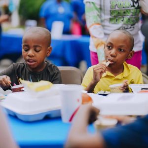 Children enjoy a hot meal at Mercy Chefs' Back-to-School Block Party
