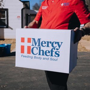 Chef John holds a Family Grocery Box