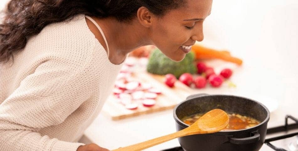 woman smelling her food cooking