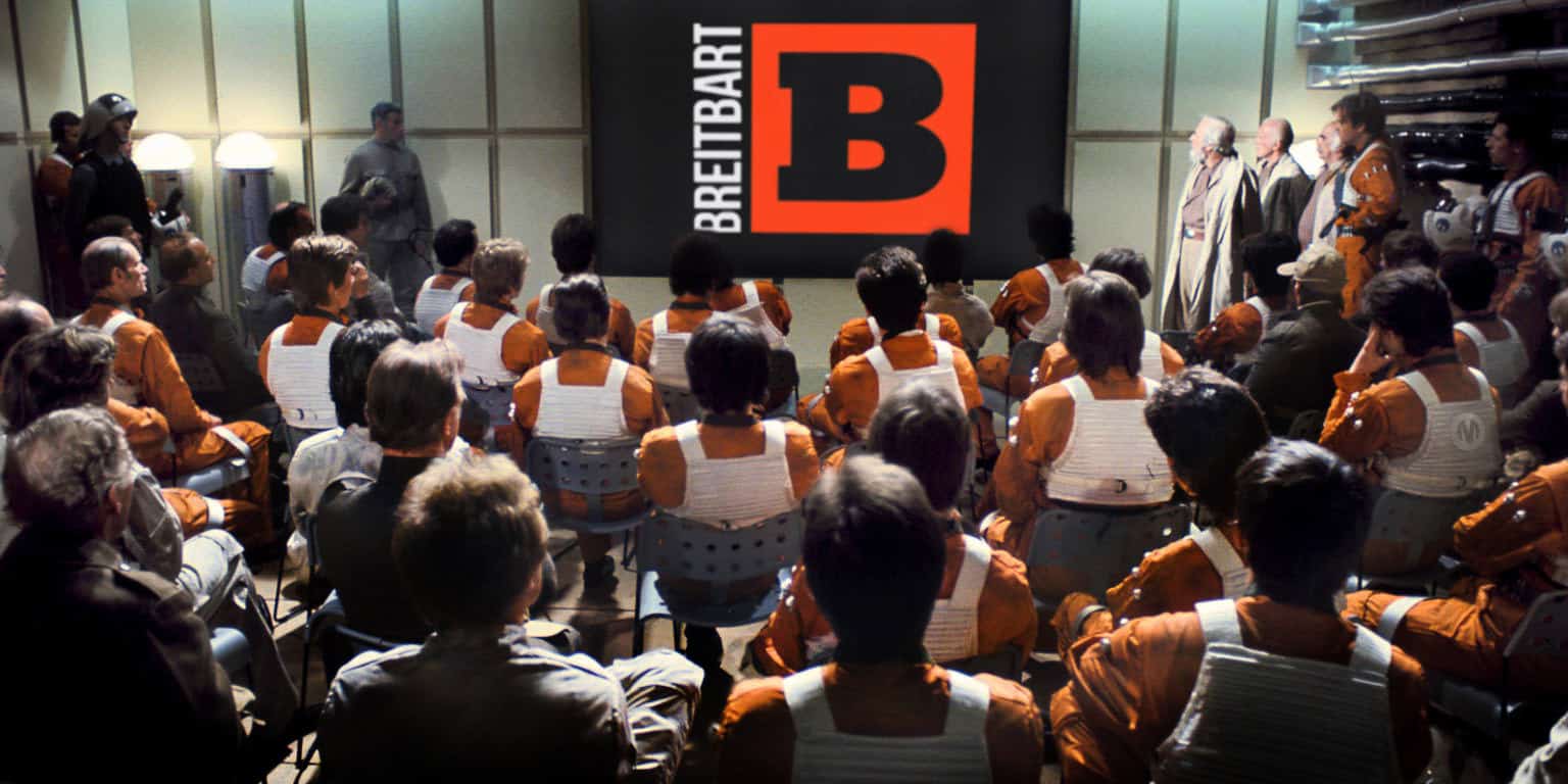 Audience watching a Breitbart event with a large logo backdrop.