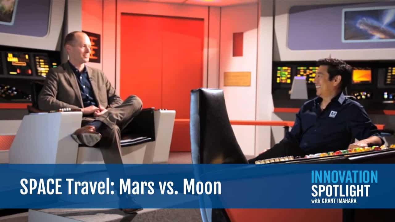 Two scientists discussing space travel between Mars and Moon in a control room.