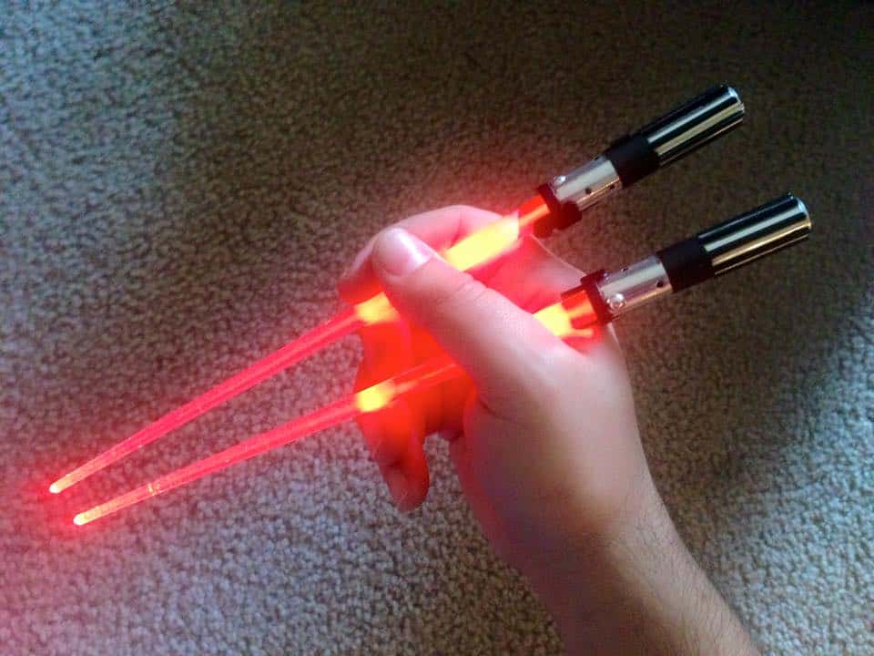 Hand holding a custom laser lightsaber with red laser blades.