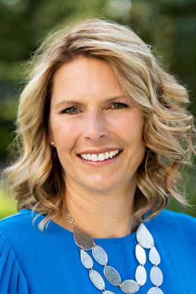 Professional woman smiling outdoors, representing MHP healthcare services.
