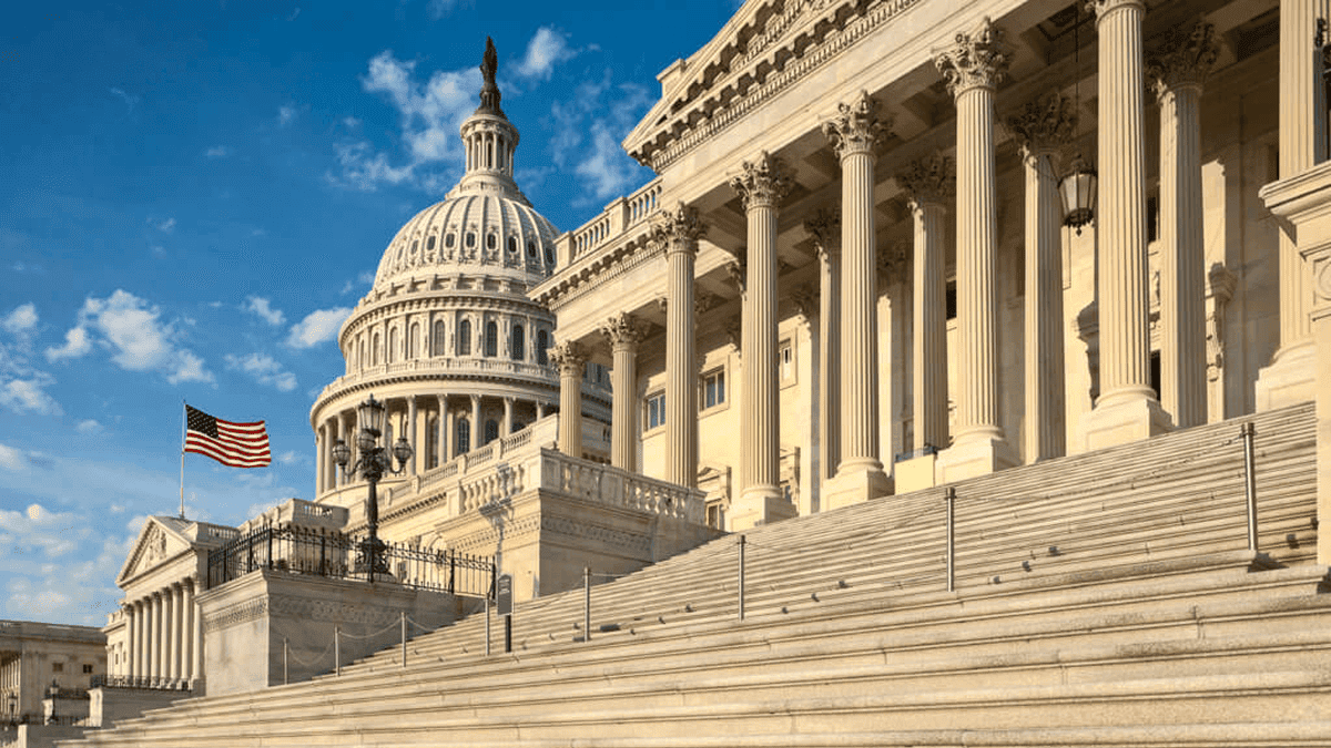 U.S. Capitol with grand stairs and columns, symbol of American democracy and government.