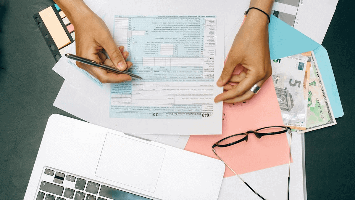 Tax documents and financial planning tools on a workspace.