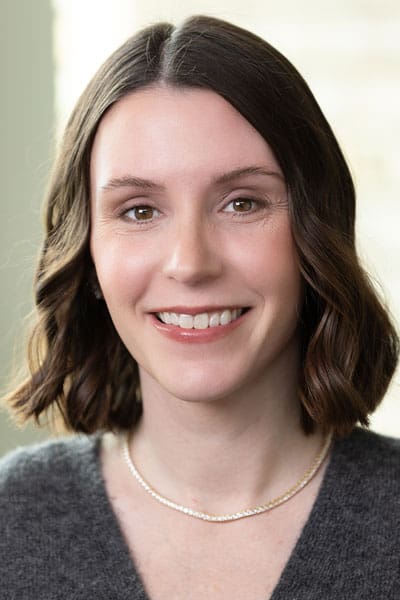 Smiling woman with healthy skin, representing wellness and healthcare services at MHP.