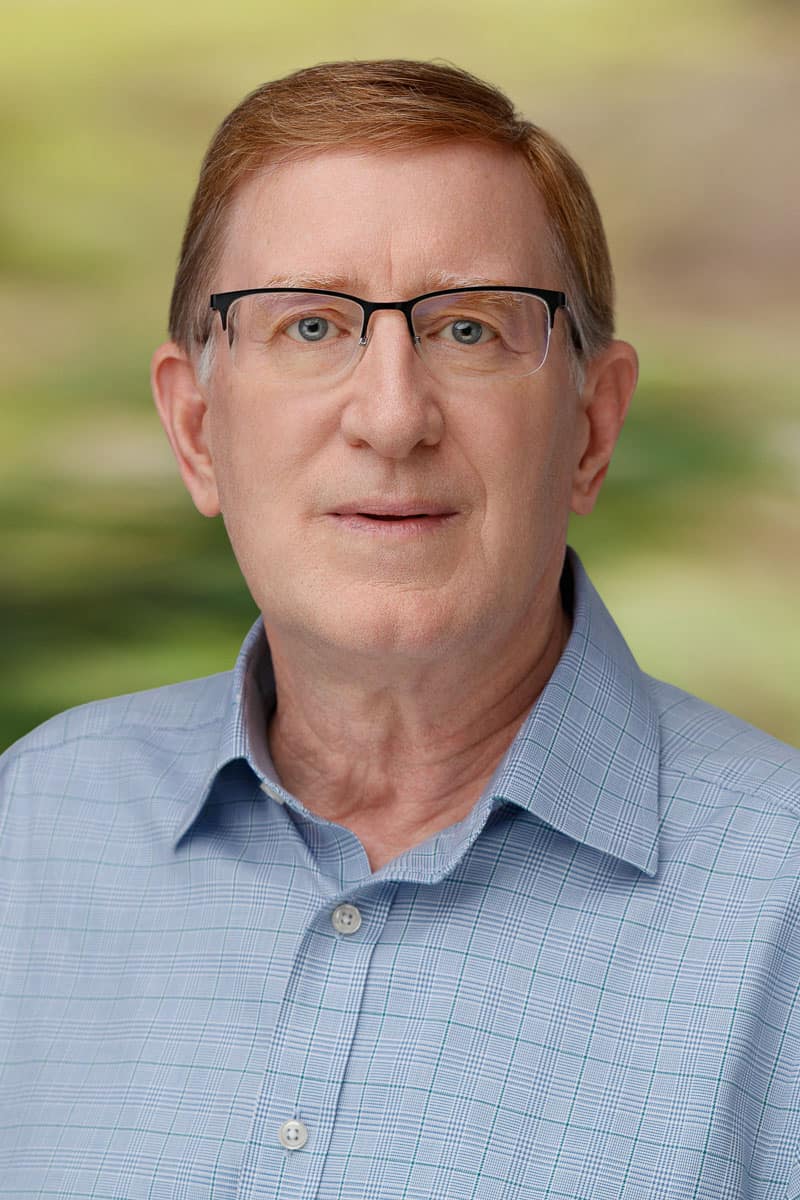 Portrait of Rick Palmer, CPA in professional attire outdoors.