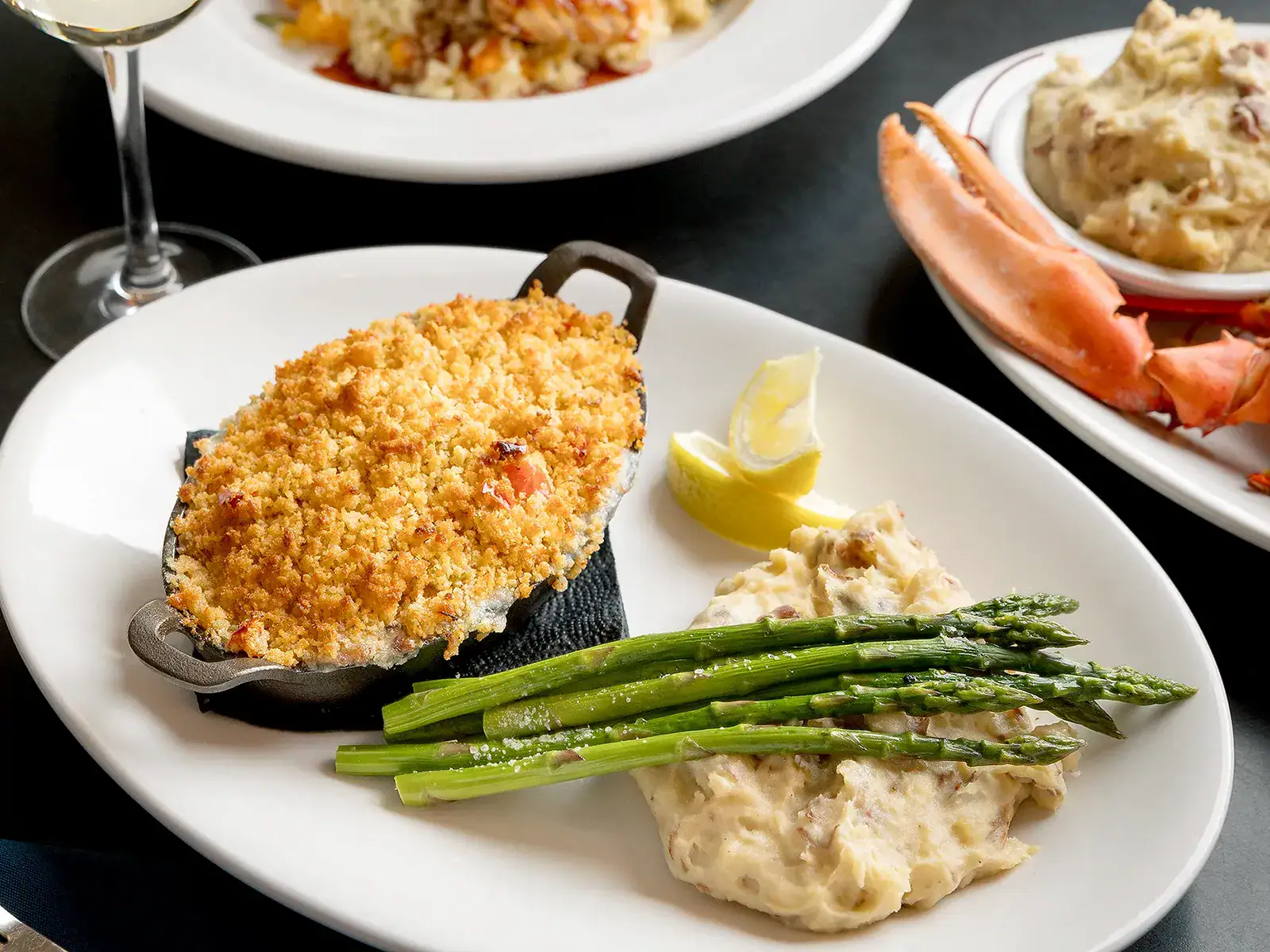 Fried seafood dish with asparagus, mashed potatoes, and lemon wedge at Michael's Harborside.