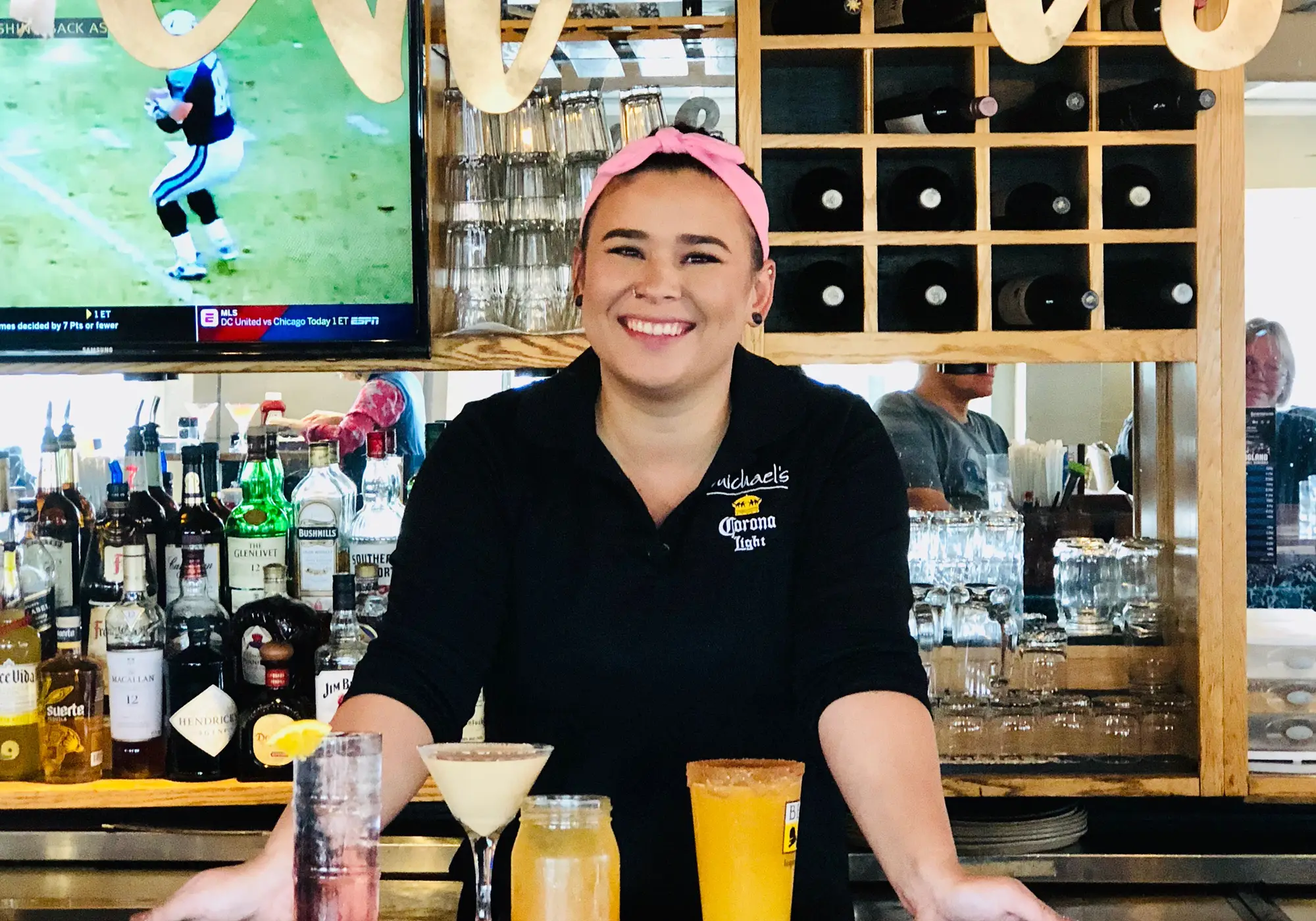 Staff member serving drinks at Michael’s Harborside in Newburyport, MA