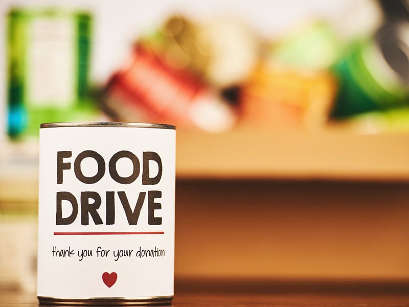 Food drive donation can with thank you message and heart symbol.
