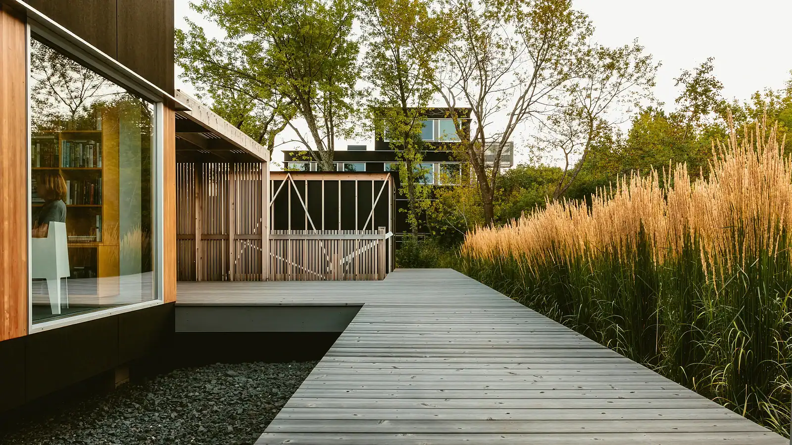 Modern wooden fence with lush landscaping and a deck in a contemporary outdoor space.