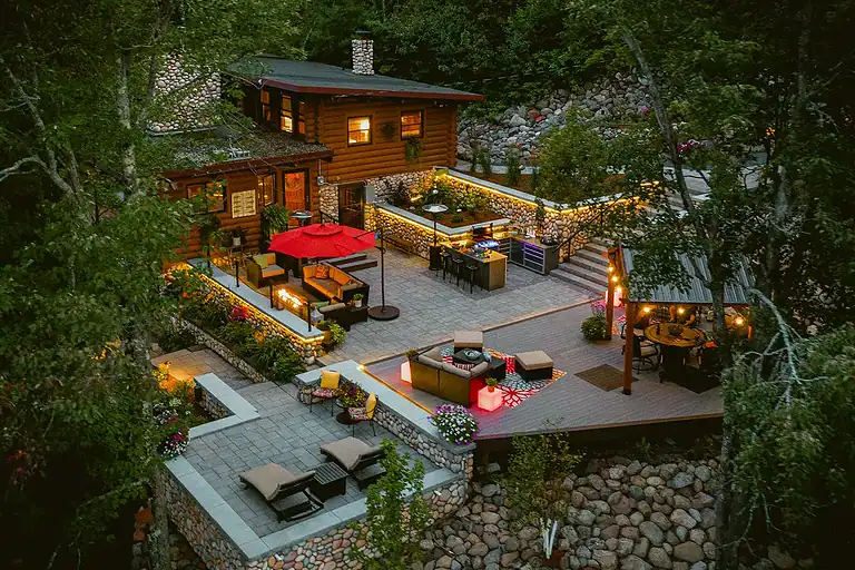 Beautiful landscaped plantings surrounding a cozy outdoor patio area.