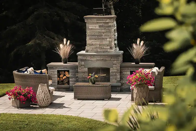 Beautiful outdoor horse arena with seating and landscaping.