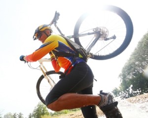 cyclist is carrying his bike