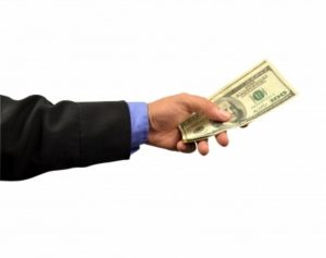 hand giving a hundre-dollar bil