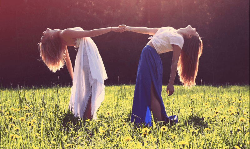 two women in a field of flowers with passion