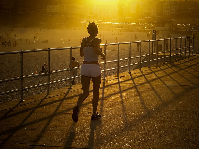 woman running near the beach at sunset