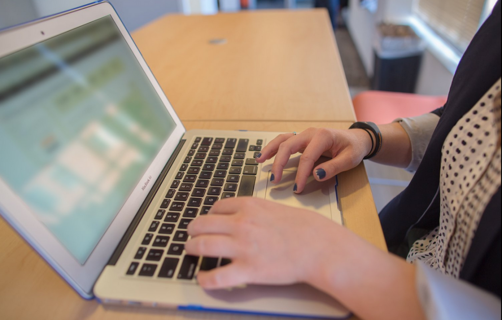 woman typing on computer being creative