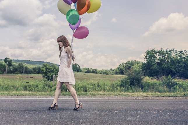 girl walking with balloons