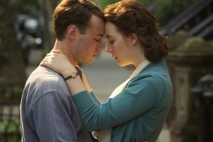 Emory Cohen as "Tony" and Saoirse Ronan as "Eilis" in BROOKLYN. Photo by Kerry Brown. © 2015 Twentieth Century Fox Film Corporation All Rights Reserved