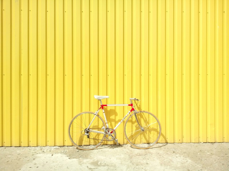 bike against yellow wall