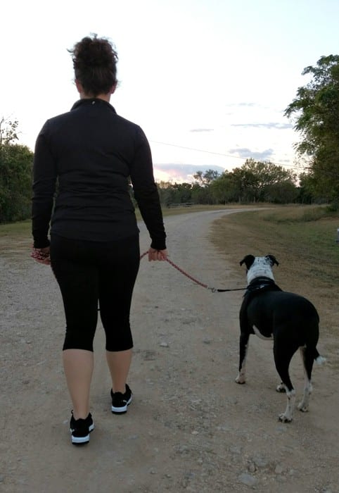 girl walking dog thinking about retail job